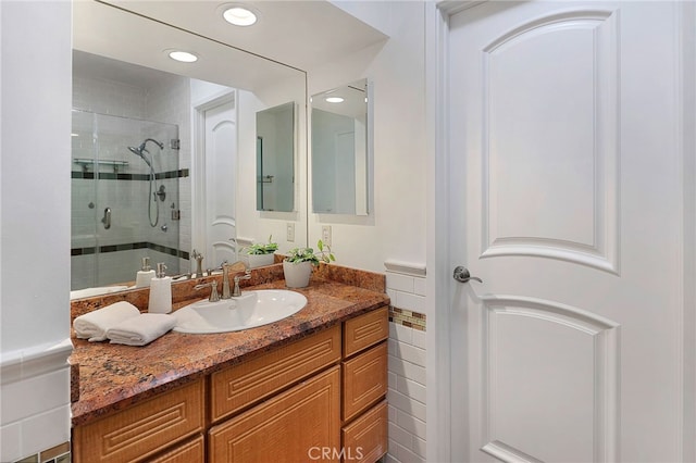 bathroom with vanity, recessed lighting, and a shower stall