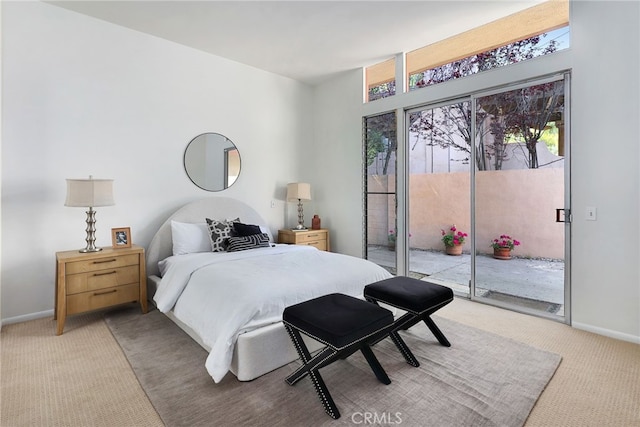 bedroom with baseboards, access to outside, and light carpet