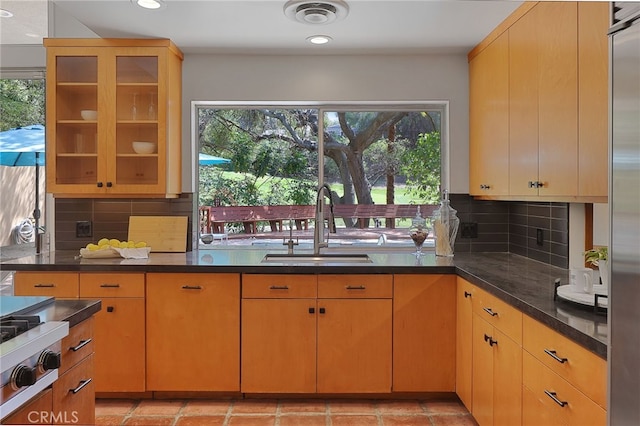 kitchen featuring recessed lighting, a sink, decorative backsplash, and visible vents
