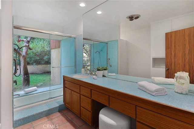 full bath featuring vanity, tile patterned floors, plenty of natural light, a tub to relax in, and a shower with door