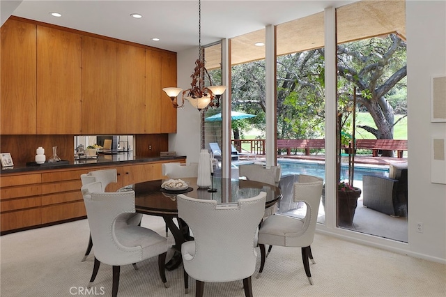 dining area featuring recessed lighting, a notable chandelier, and light carpet