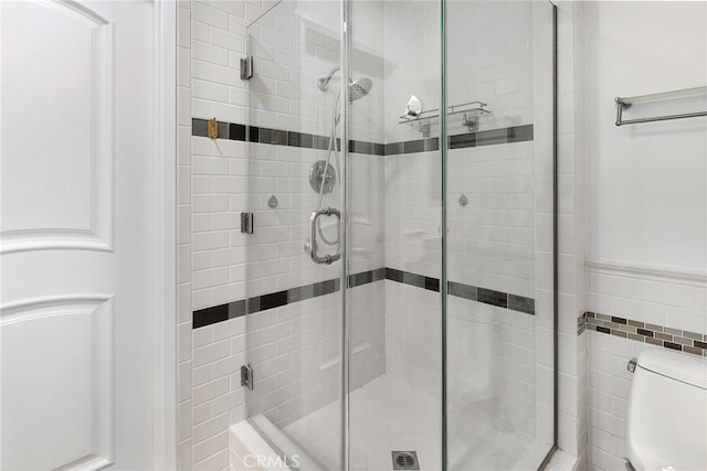 bathroom with toilet and a shower stall