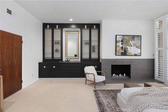 living area featuring visible vents, recessed lighting, carpet floors, and a fireplace