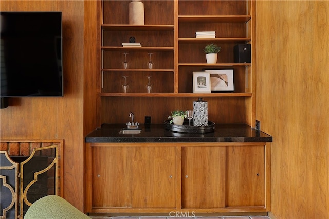 bar with indoor wet bar and a sink