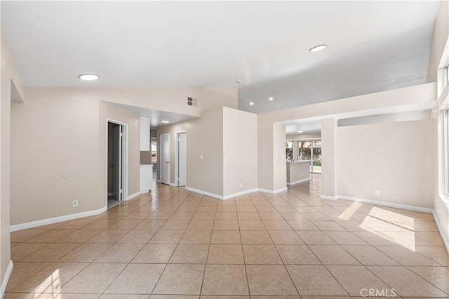 unfurnished living room with recessed lighting, baseboards, visible vents, and light tile patterned floors