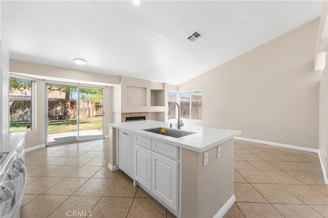 kitchen featuring visible vents, light tile patterned flooring, a sink, dishwasher, and vaulted ceiling