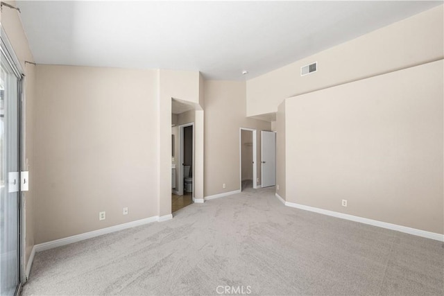 empty room featuring baseboards, carpet, and visible vents