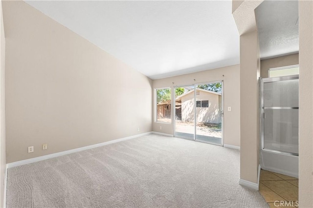 empty room featuring carpet floors and baseboards