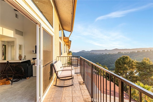 balcony featuring a mountain view and visible vents