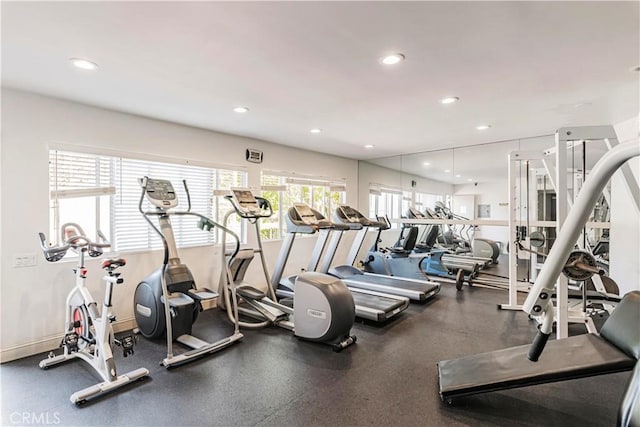 workout area featuring recessed lighting and baseboards
