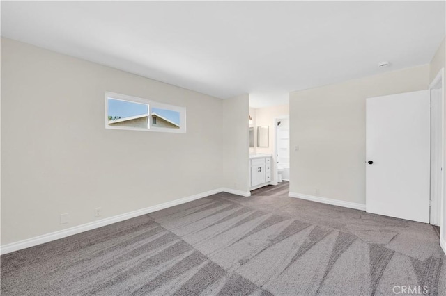 empty room with dark carpet and baseboards