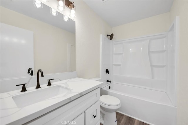 bathroom featuring vanity, shower / bathing tub combination, toilet, and wood finished floors