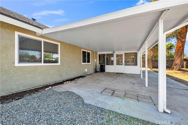 view of patio / terrace with central AC and fence