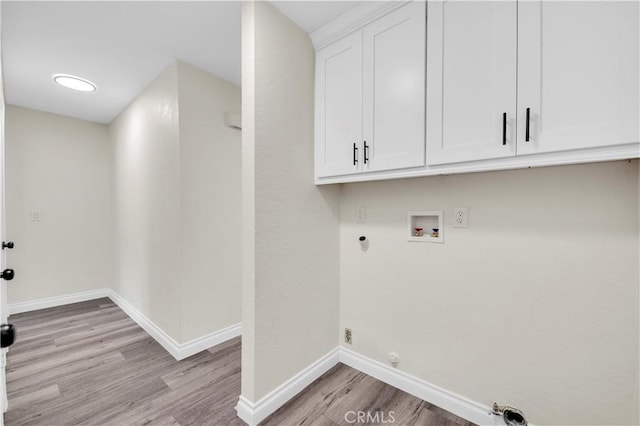 laundry room featuring cabinet space, hookup for a washing machine, light wood-style flooring, baseboards, and hookup for a gas dryer
