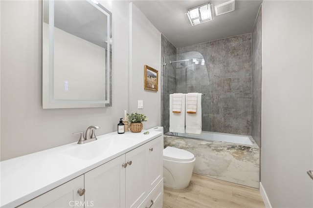 full bathroom with visible vents, wood finished floors, toilet, and vanity