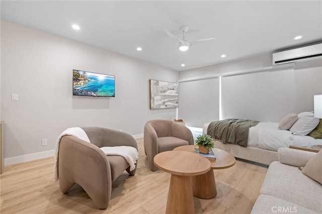 living area featuring light wood-type flooring, baseboards, a wall mounted AC, and recessed lighting