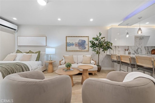 living area featuring recessed lighting, baseboards, a wall mounted AC, and light wood-style flooring