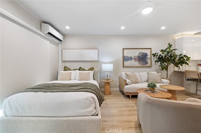 bedroom featuring light wood-style floors, recessed lighting, and a wall mounted air conditioner