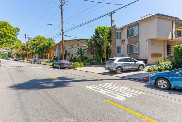 view of road with sidewalks, street lighting, and curbs
