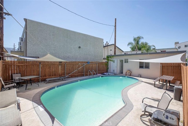 view of swimming pool featuring a patio, a fenced in pool, and a fenced backyard