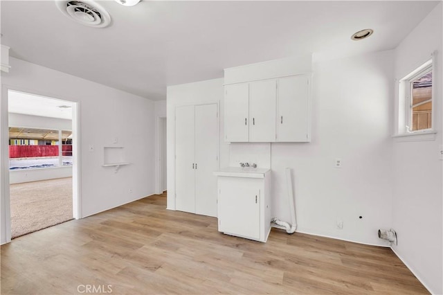 laundry room featuring visible vents and light wood finished floors