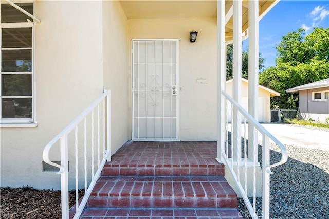 property entrance with stucco siding