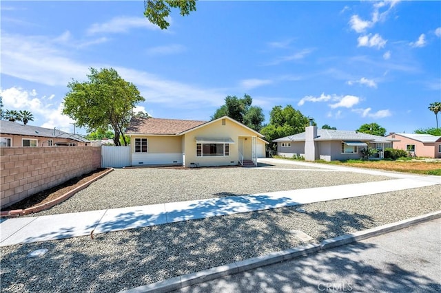 view of front of property with an attached garage, fence, driveway, and stucco siding