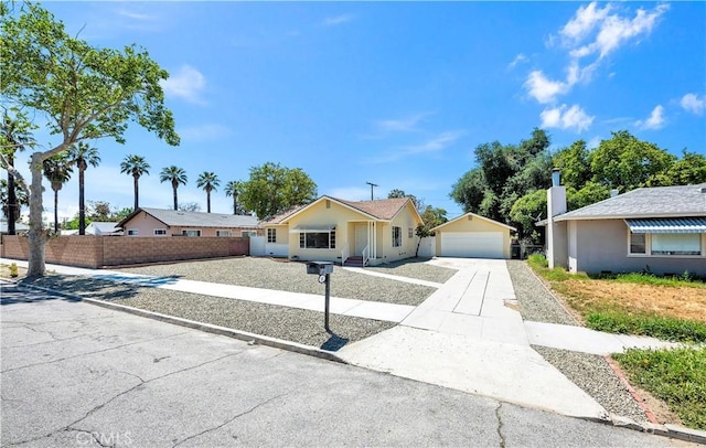 view of front of home featuring fence and a detached garage