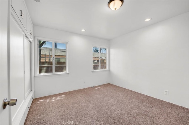 carpeted empty room featuring recessed lighting
