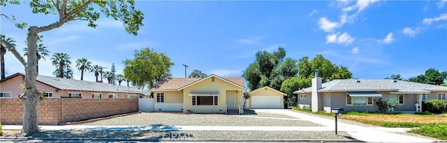view of front of property with a garage, fence, stucco siding, a chimney, and driveway