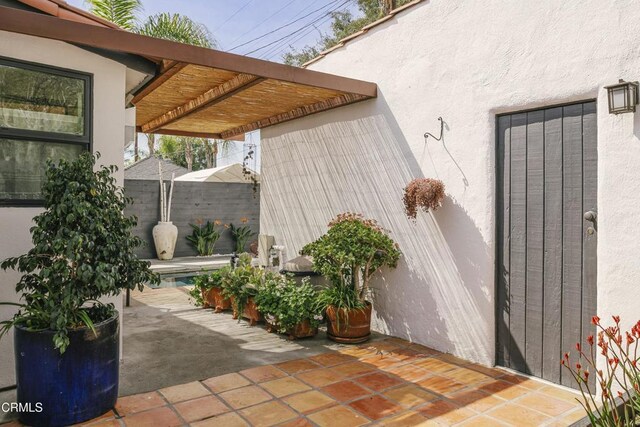 1241 Solita Rd, Pasadena, CA 91103 - property entrance featuring fence, a pergola, stucco siding, and a patio area