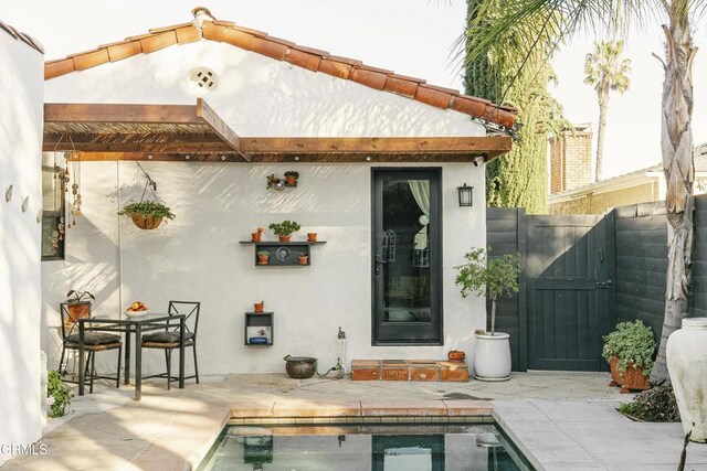 1241 Solita Rd, Pasadena, CA 91103 - back of house featuring fence, stucco siding, a fenced in pool, a gate, and a patio area