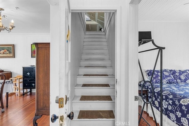 117 Maiden Ln, Avalon, CA 90704 - stairs featuring wood finished floors and a chandelier