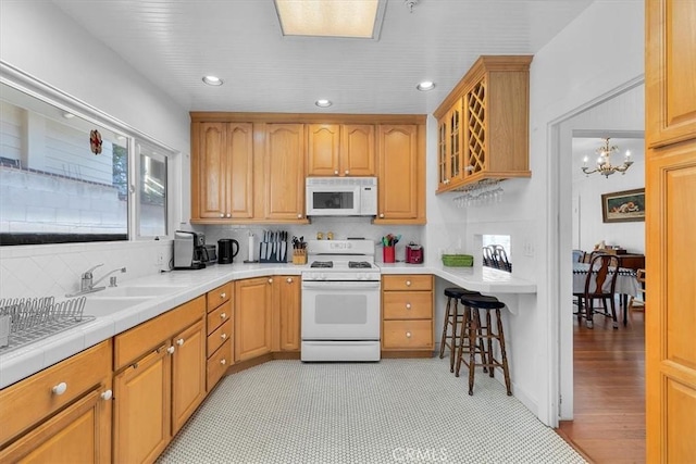 117 Maiden Ln, Avalon, CA 90704 - kitchen featuring tasteful backsplash, a sink, glass insert cabinets, recessed lighting, and white appliances
