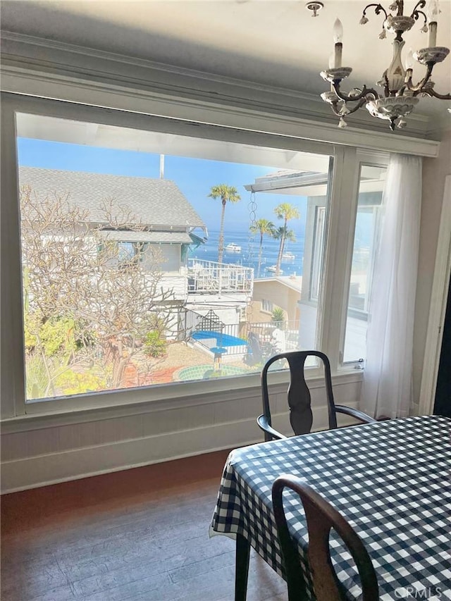 117 Maiden Ln, Avalon, CA 90704 - dining room featuring crown molding, a water view, wood-type flooring, and a chandelier