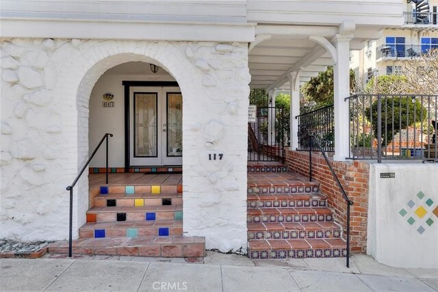 117 Maiden Ln, Avalon, CA 90704 - doorway to property with a porch and stone siding