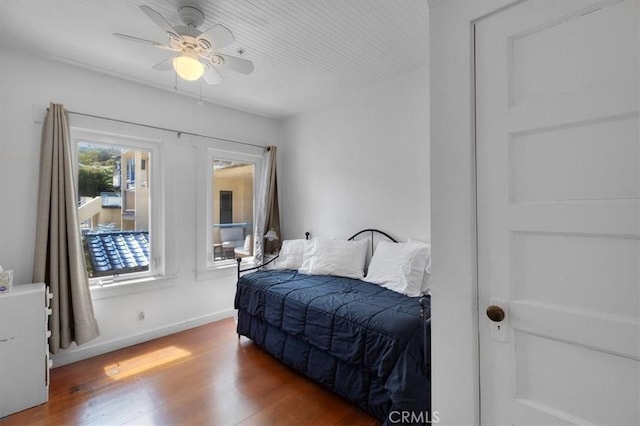117 Maiden Ln, Avalon, CA 90704 - bedroom with baseboards, a ceiling fan, and wood finished floors