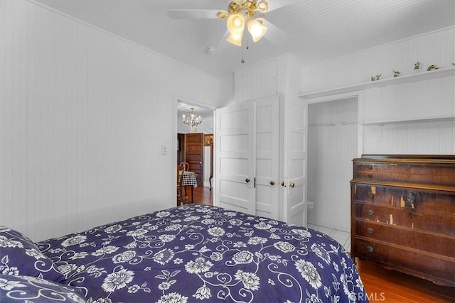 117 Maiden Ln, Avalon, CA 90704 - bedroom featuring a closet, ceiling fan with notable chandelier, and wood finished floors