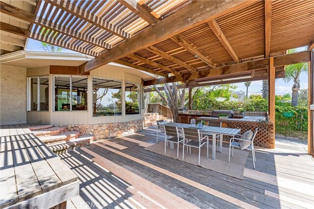 wooden terrace featuring fence, a pergola, and outdoor dining area