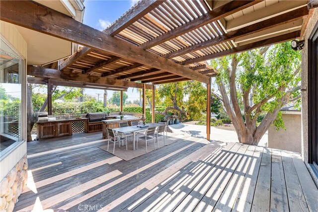 wooden terrace with a pergola, outdoor dining area, and a grill