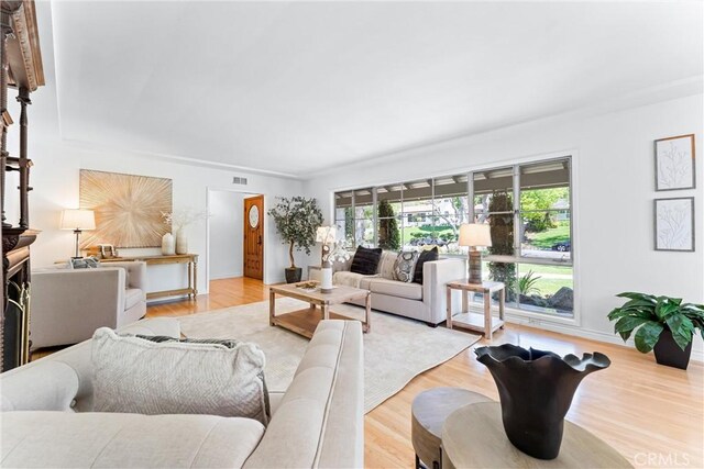 living area featuring baseboards and wood finished floors