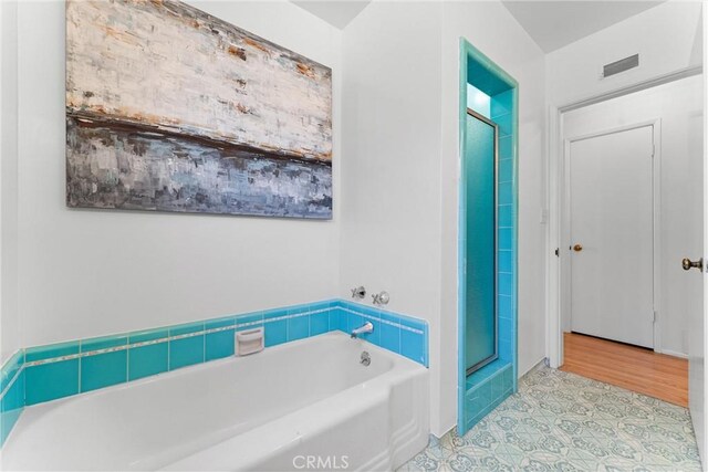 full bath featuring visible vents, a stall shower, and a garden tub
