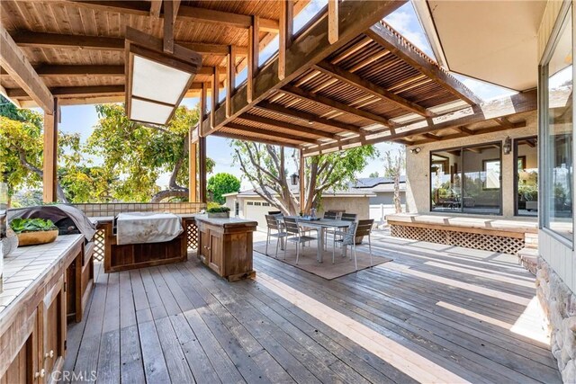 wooden terrace featuring outdoor dining space