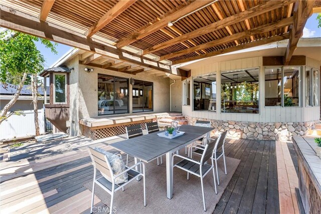 wooden terrace featuring fence and outdoor dining space