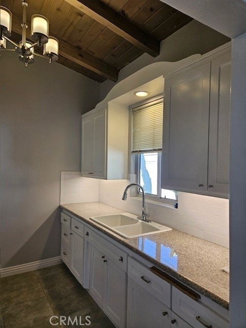 3315 Strongs Dr, Venice, CA 90292 - kitchen featuring white cabinets, wood ceiling, baseboards, and a sink