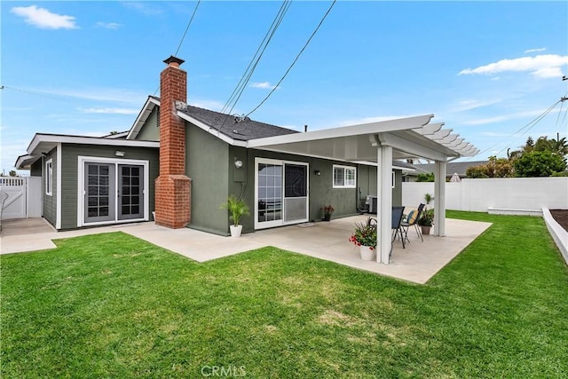 19822 Westwinds Ln, Huntington Beach, CA 92646 - back of house featuring a yard, a chimney, fence private yard, and a patio area