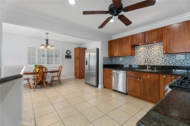 19822 Westwinds Ln, Huntington Beach, CA 92646 - kitchen with pendant lighting, tasteful backsplash, a sink, ceiling fan with notable chandelier, and stainless steel appliances