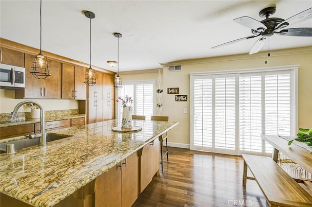 166 N Singingwood St Unit 9, Orange, CA 92869 - kitchen with ceiling fan, a sink, dark wood finished floors, stainless steel microwave, and visible vents