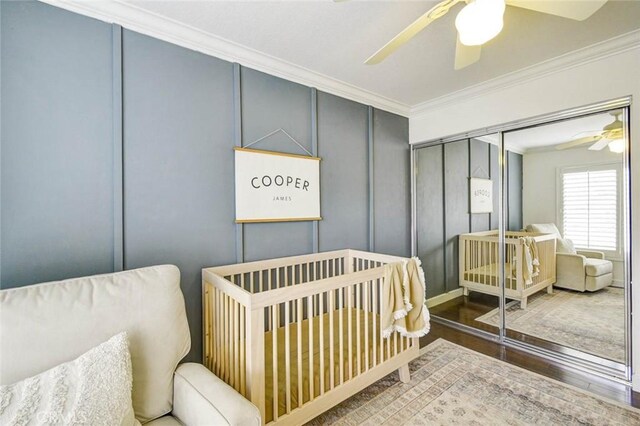 166 N Singingwood St Unit 9, Orange, CA 92869 - bedroom featuring a ceiling fan, wood finished floors, a closet, ornamental molding, and a decorative wall