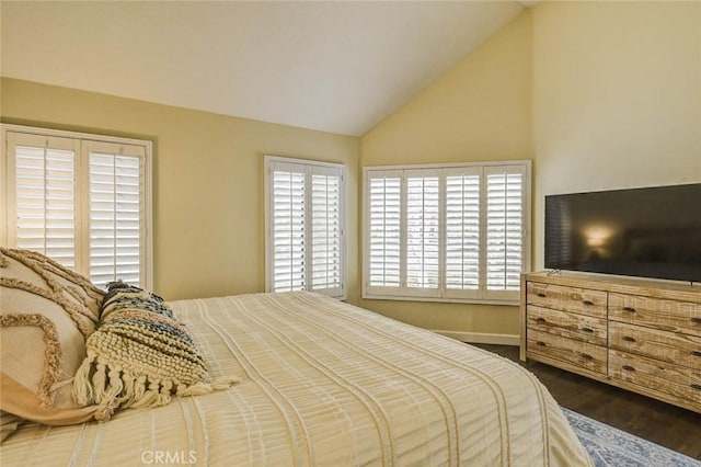 166 N Singingwood St Unit 9, Orange, CA 92869 - bedroom featuring baseboards, wood finished floors, and vaulted ceiling